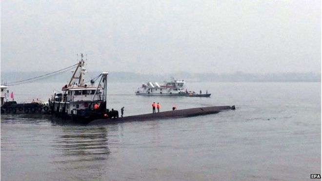 Rescuers work on the capsized passenger ship in the Yangtze River, searching for missing passengers in Jianli, Hubei province, China, 2 June 2015.