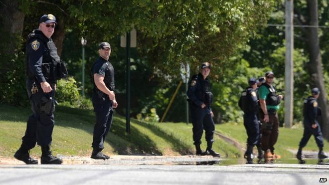 Law enforcement officers sweep through Smith Street in Dannemora on 6 June during a search for escaped prisoners