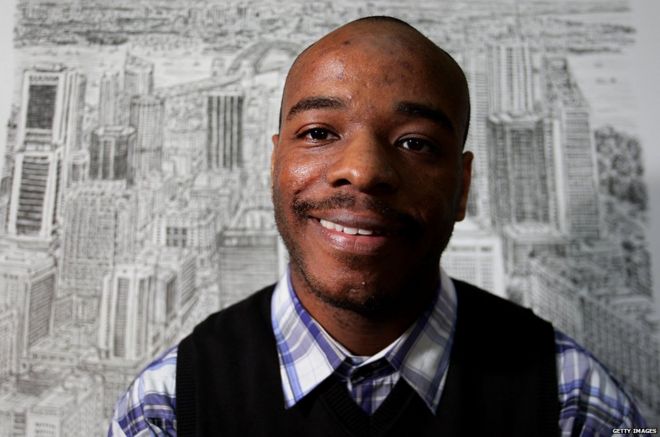 Stephen Wiltshire in front of one of his cityscapes