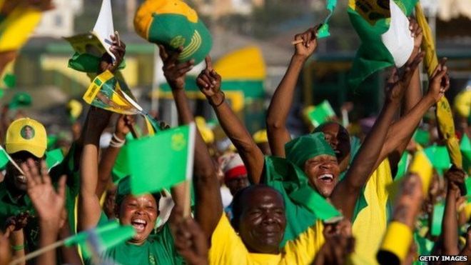 Supporters cheer Tanzanian President Jakaya Kikwete as their leader delivers a speech on October 30, 2010 during the final campaign rally in Dar Es Sallam on the eve of elections he is expected to win.