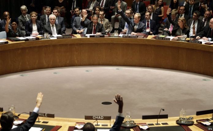 Members of the United Nations Security Council (UNSC) vote on a resolution in New York on 29 July