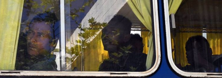 Migrants looks out from a bus after arriving at the port of Kalamata in South Peloponnese, Greece, 17 April 2016