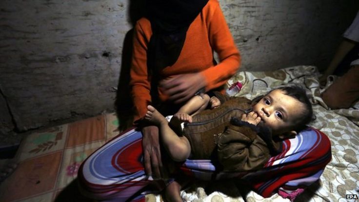 A Yemeni woman and her infant child take shelter in an underground water tunnel in Sanaa, Yemen on 30 April 2015.