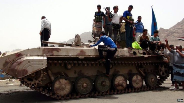 Southern Yemenis stand atop a tank of tribal militiamen loyal to Yemeni President Hadi following clashes with Houthi in Aden on 8 April, 2015