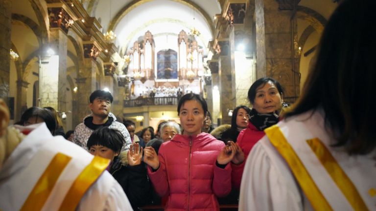 Chinese worshippers attend the Christmas Eve mass at a Catholic church in Beijing on December 25, 2015