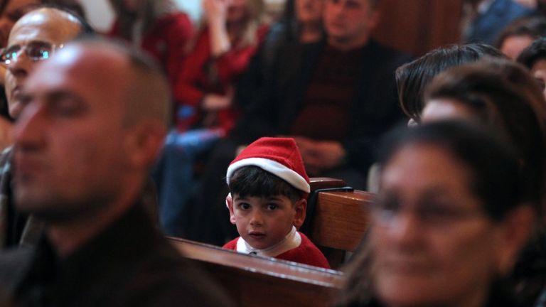 Iraqi Christians attend a Christmas mass at the Catholic Church of Our Lady of Deliverance/Salvation (Sayidat al-Nejat), in central Baghdad, on December 24, 2015.