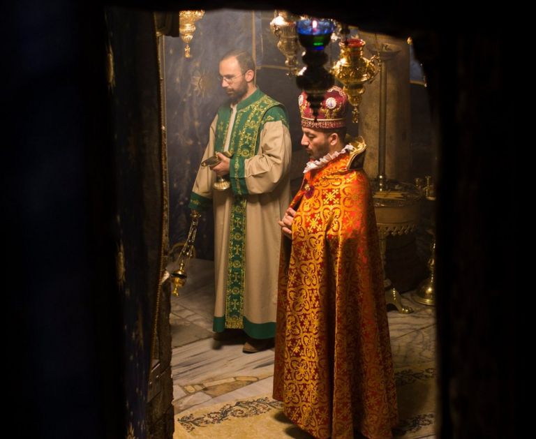 An Armenian priest prays during a morning mass at the 