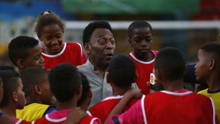 Pele with young footballers