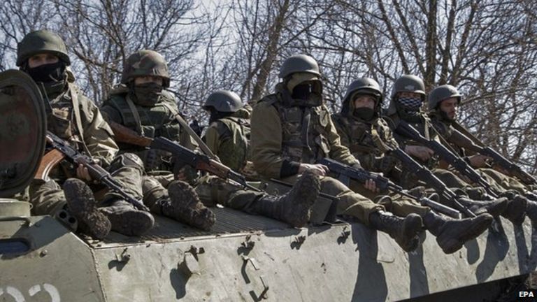 Pro-Russian rebels drive on an armoured military vehicle near city of Donetsk on 10 April 2015