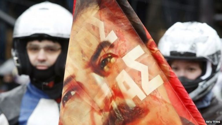 Bikers gather near a flag showing a portrait of Soviet leader Joseph Stalin before a farewell ceremony to see off participants of a bike ride, commemorating the 70th anniversary of the victory over Nazi Germany in World War Two (25 April 2015)