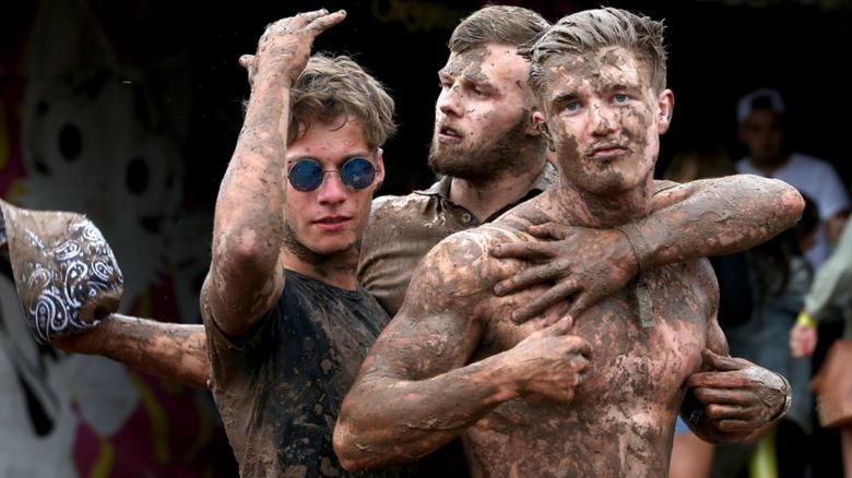 Festival-goers covered in mud at T in the Park