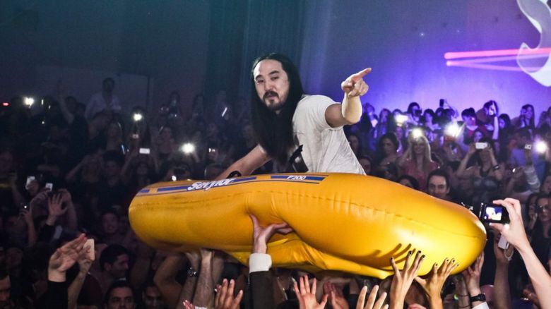 Steve Aoki rides in raft at SupperClub Los Angeles in 2012