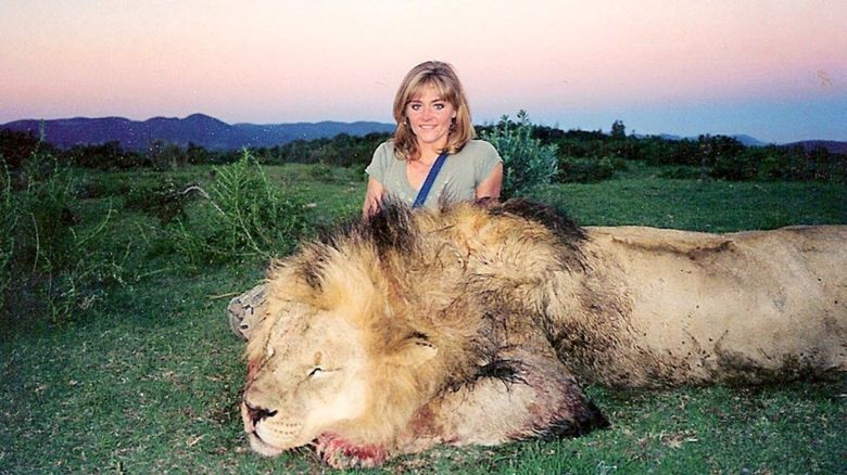 Rebecca poses with a dead lion