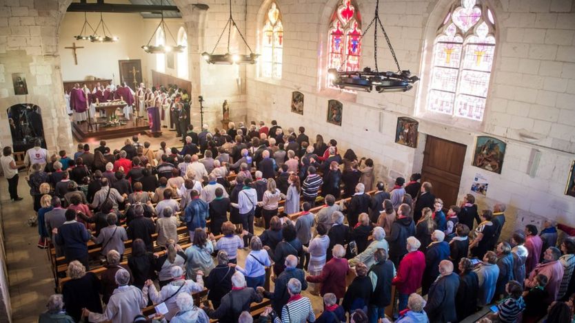 People attend a Catholic mass celebrated for re-opening of Saint Etienne church in Saint-Etienne-du-Rouvray, France, 2 October 2016
