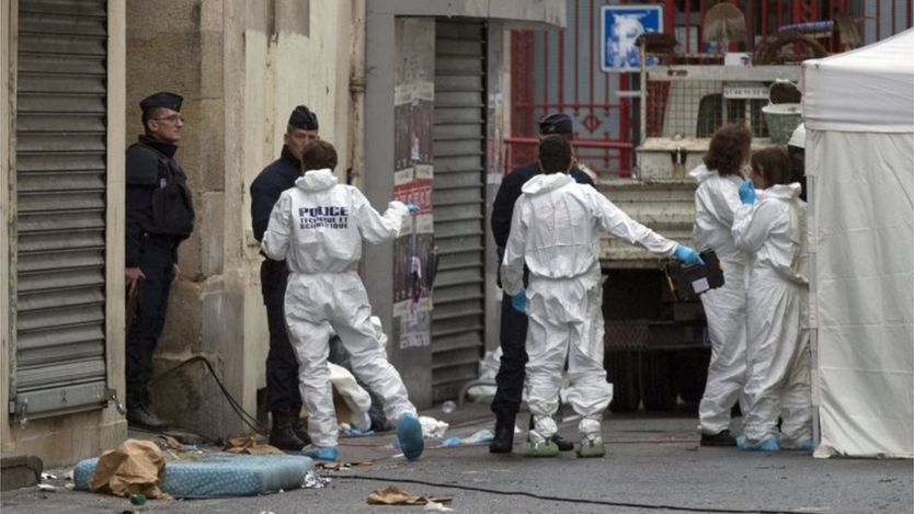 Investigating police officers are pictured outside Saint Denis, near Paris, Thursday, Nov. 19, 2015.