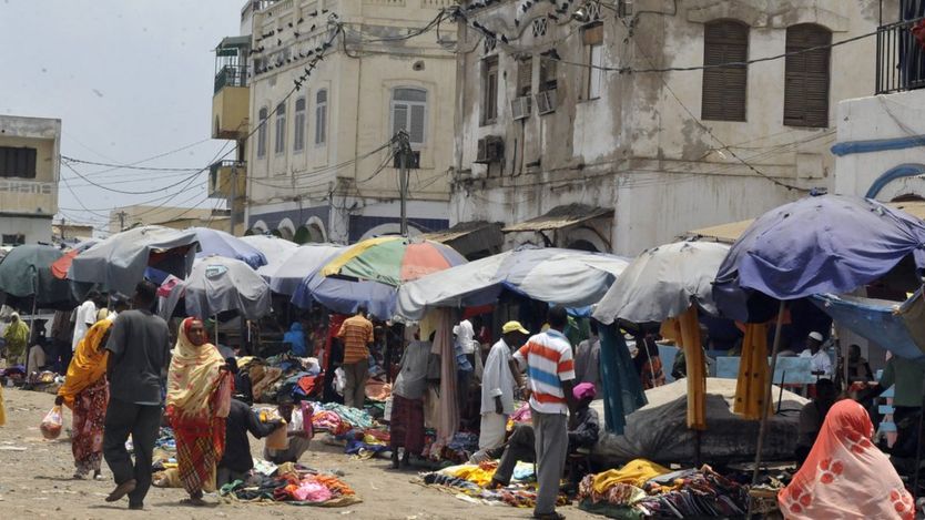 Market vendors sell their wares under umbrellas in Djibouti city
