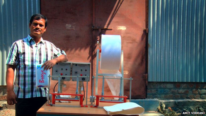 Muruganantham stands next to his invention in a still from the documentary Menstrual Man