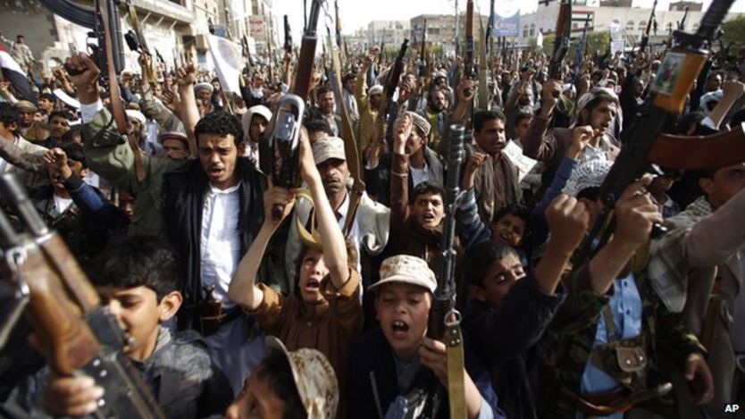 Houthi rebels hold up their weapons to denounce the Saudi-led airstrikes in Sanaa, Yemen, Monday, April 27, 2015
