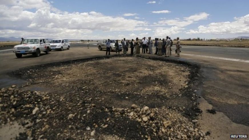 Yemeni aviation officials and humanitarian workers inspect damage to the runway at Sanaa's international airport (5 May 2015)