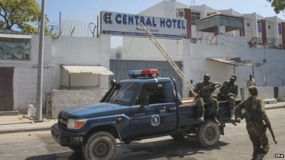 Somali security officers are seen in front of the Central Hotel in Mogadishu, Somalia, 20 February 2015