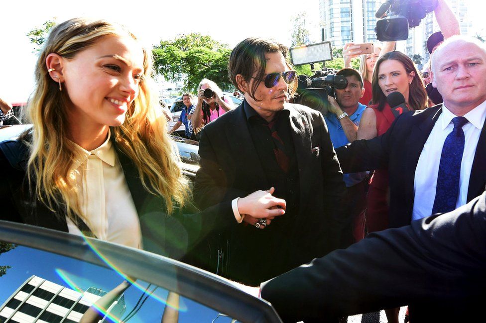 US actor Johnny Depp (second from right) and his wife, US actress Amber Heard arrive at Southport Magistrates Court on the Gold Coast, Australia