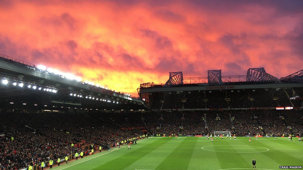 Red sunset over a football stadium