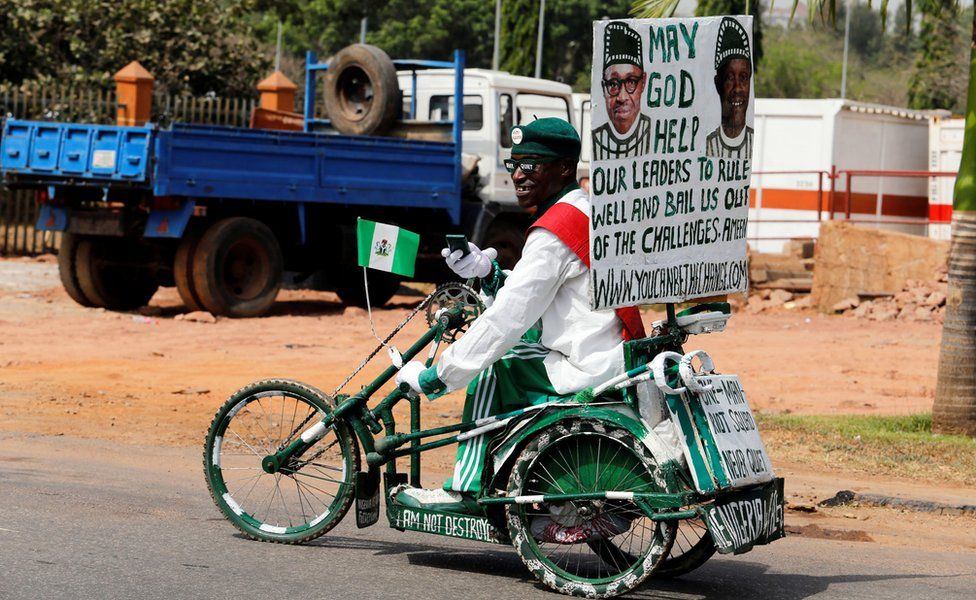 A supporter of President Muhammadu Buhari on a white and green painted tricycle in Abuja, Nigeria - Monday 6 February 2017