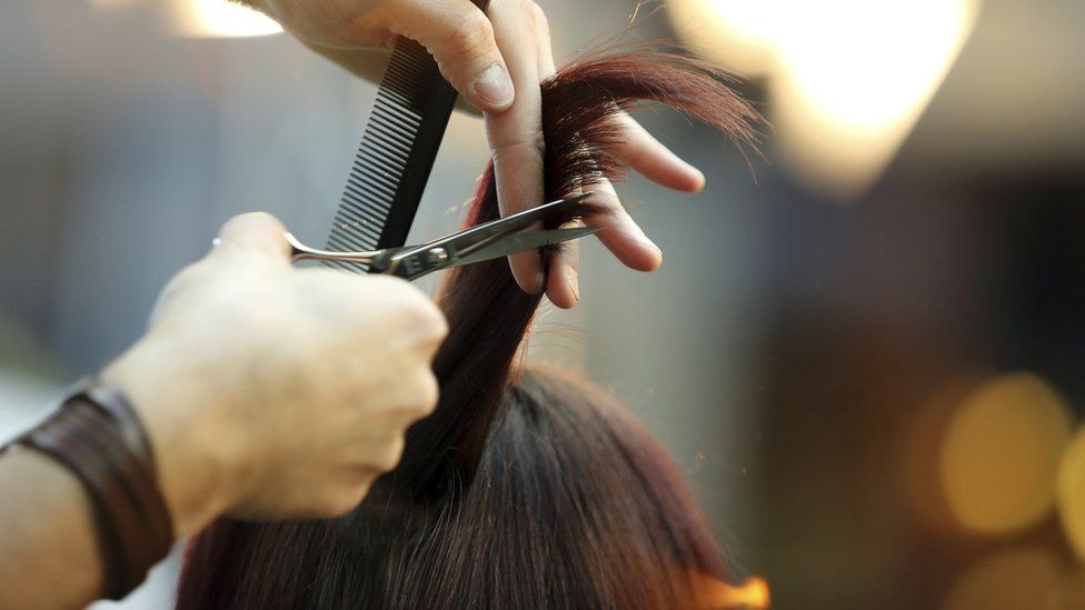Hands cutting hair