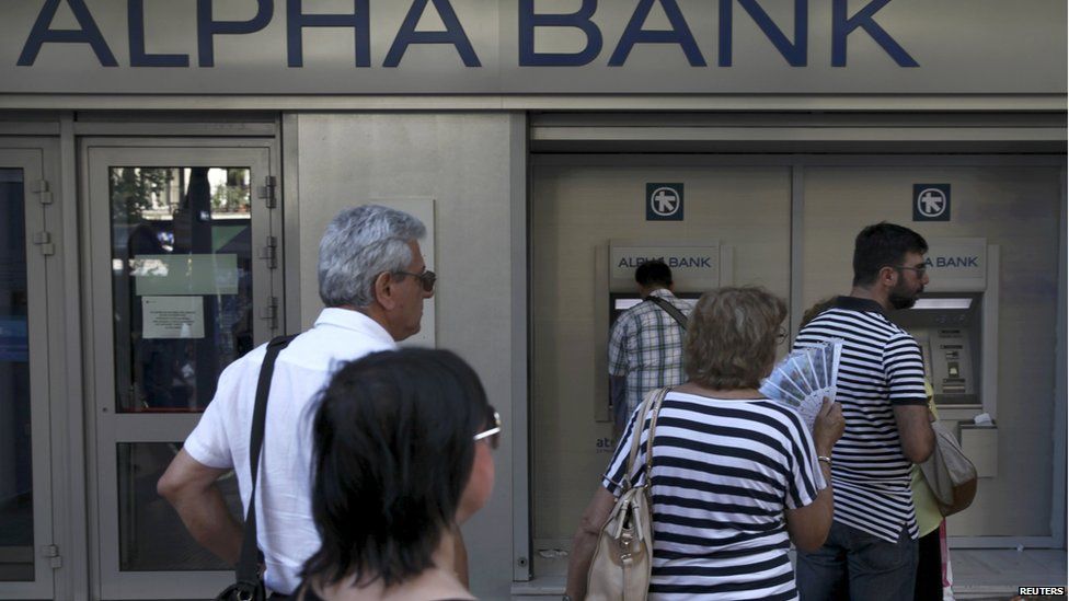 People queue at an ATM in Athens