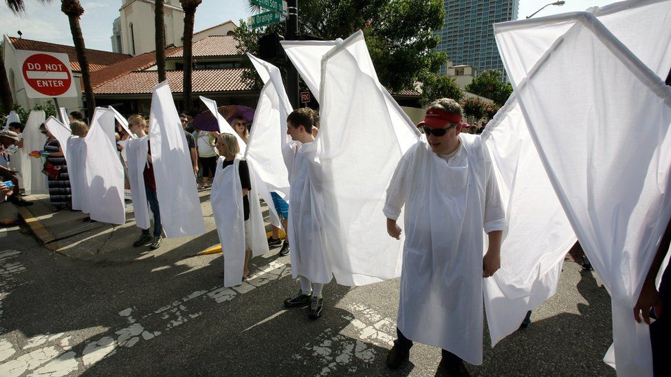 People wearing angel wings