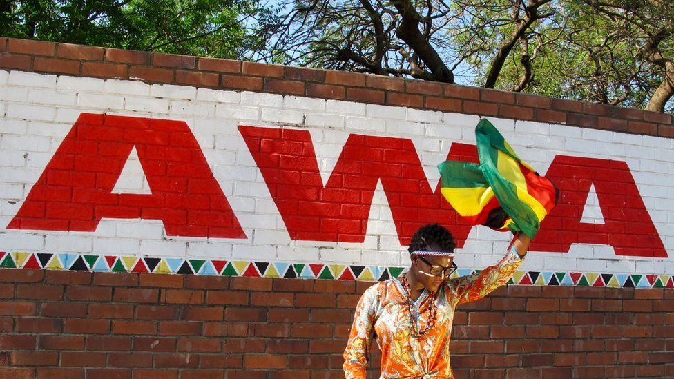 AWA waving a Zimbabwe flag