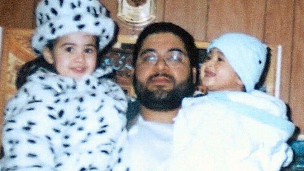 Shaker Aamer holding two of his children
