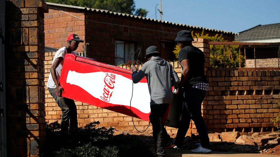 People stealing a fridge near Pretoria, South Africa
