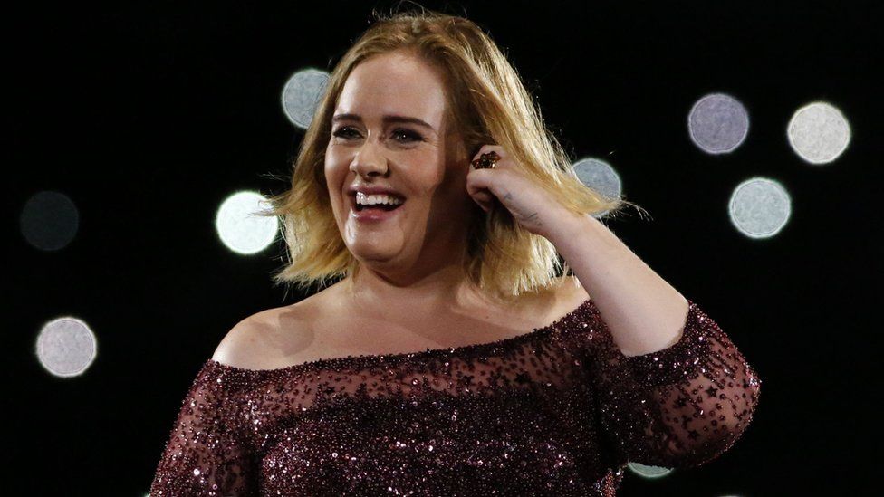 Adele smiling on stage