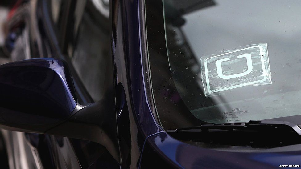 Uber sticker in car window