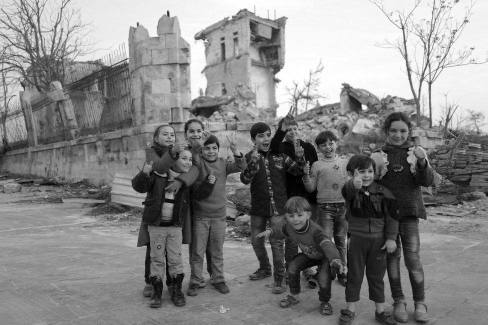 Children pose for a photo in Aleppo