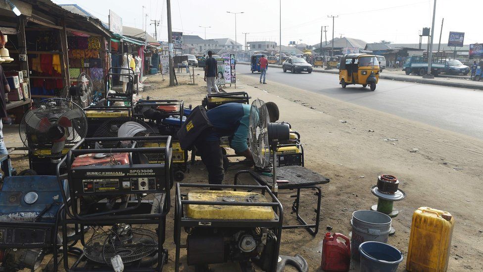 A roadside mechanic repairs electricity generators that are believed to contribute to the pollution