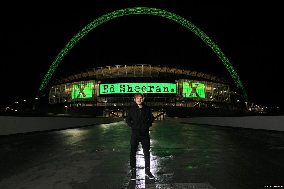 Ed Sheeran standing outside Wembley Stadium