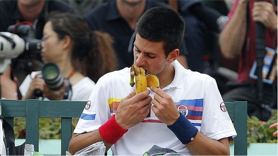 Novak Djokovic eating a banana