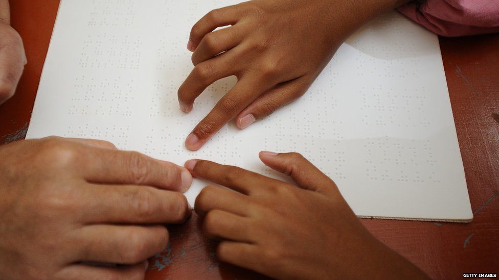 A girl learning Braille