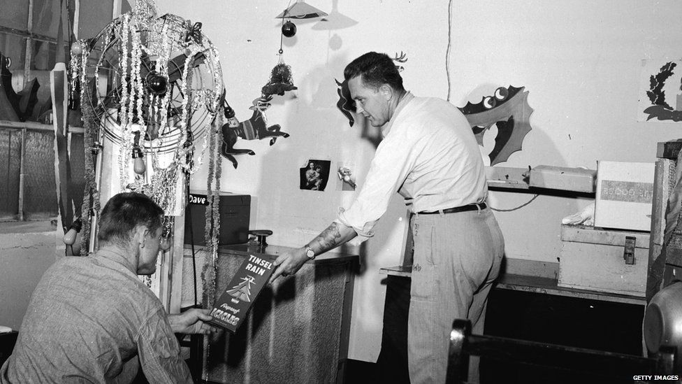 Two men decorating a prison