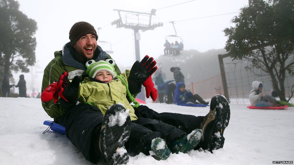 Craig and Cooper Hecht snow play on the toboggan during a cold snap on July 11, 2015 in Mount Buller, Australia.
