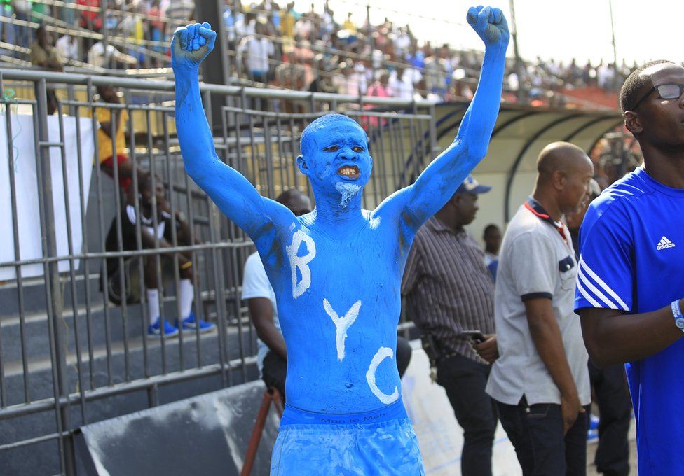 A Liberian football fan with body painted in blue cheers before a match between on 19 March 2017
