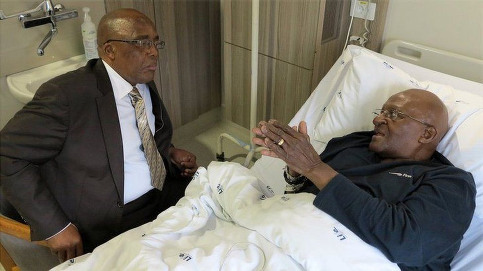 South Africa's Archbishop Desmond Tutu (R) and Health Minister Aaron Motsoaledi