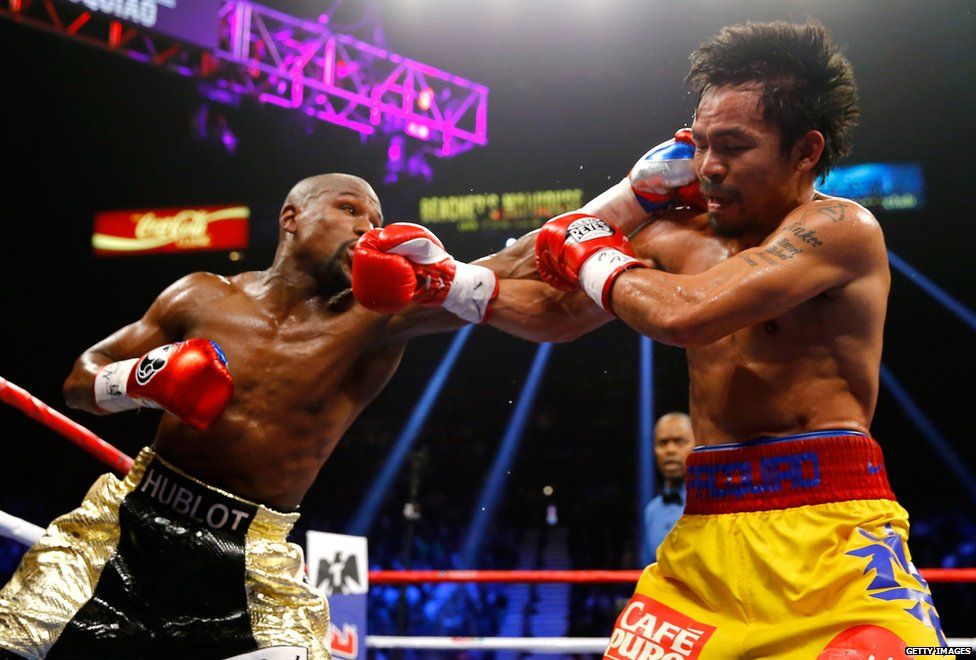 Floyd Mayweather and Manny Pacquiao exchange punches during the "fight of the century"