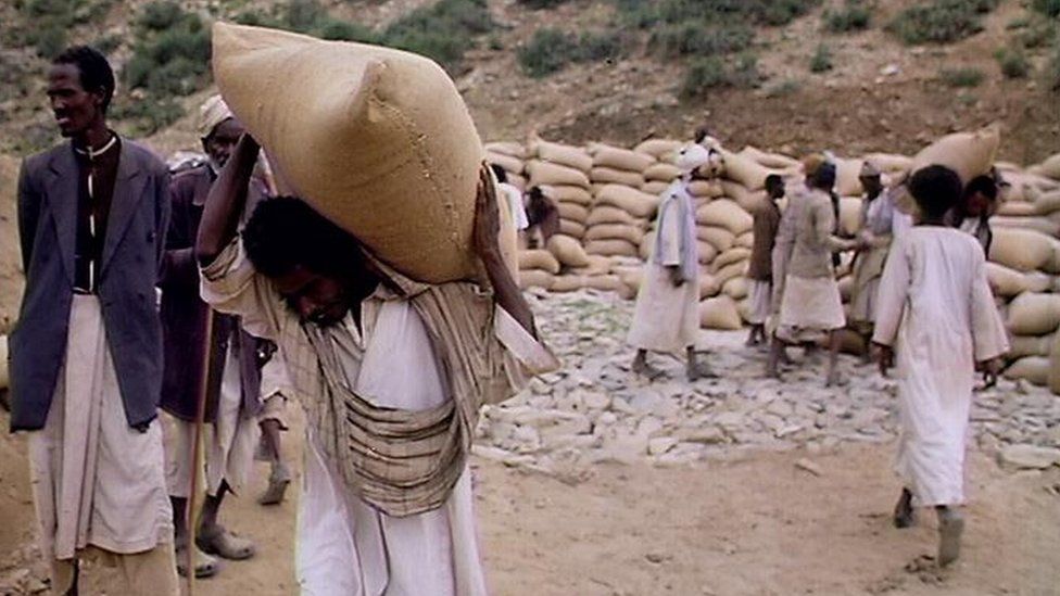 Men carrying sacks