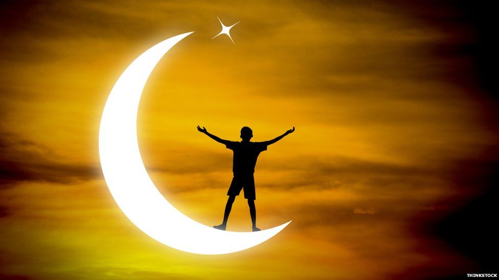Boy praying on symbol of Islam