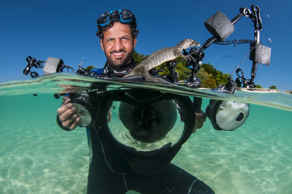 Water monitor lizard with Ali Bin Thalith - Sipadan Island, Sabah, Malaysia