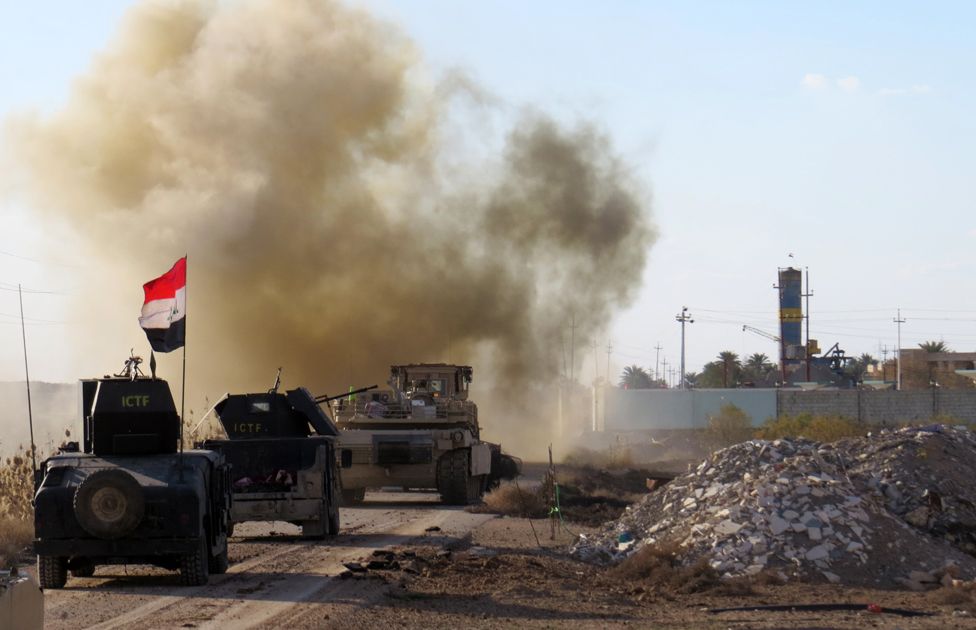 Iraqi forces drive their armoured vehicles in the Jwaibah area, on the eastern outskirts of Ramadi, on February 8, 2016, after they retook the region from Islamic State