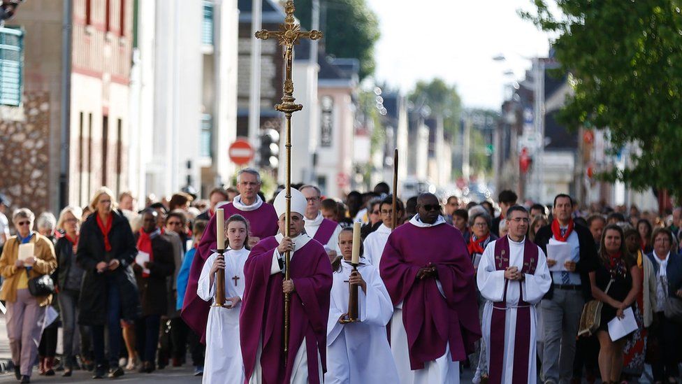 Archbishop Dominique Lebrun leads a procession through Saint-Etienne-du-Rouvray, France, prior to a special Mass. 2 Oct 2017